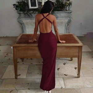 Close-up of wine red backless maxi dress with stylish crisscross straps and side ruching