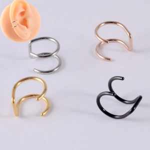 Detail of four multi-layer ear cuffs in silver, rose gold, gold and black on ear model