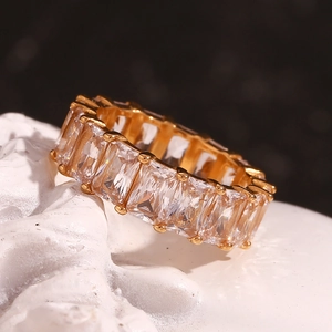 Macro shot of 18K gold plated ring featuring full channel set baguette cut cubic zirconia