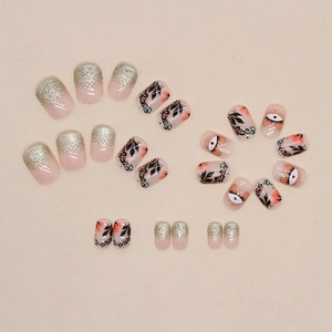 Sparkly black leaf and heart eye gradient press-on nails set with silver glitter