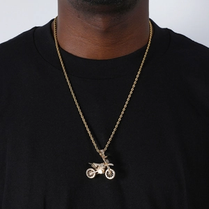 Detail of hip hop motorcycle pendant with rhinestones on a gold rope chain necklace
