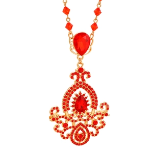 Macro detail of luxury red crystal pendant necklace with intricate gold alloy settings