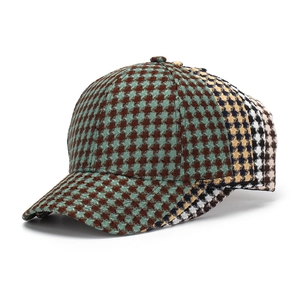 Close-up of vintage houndstooth texture and stitching details on a baseball cap