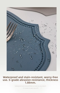 Detail of 1.88mm waterproof navy blue faux leather placemat with embossed totem edge