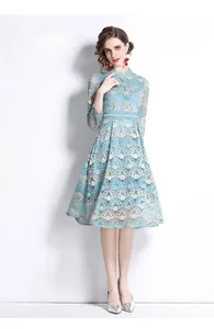Detail of light blue lace embroidery dress with intricate hollow-out wave patterns
