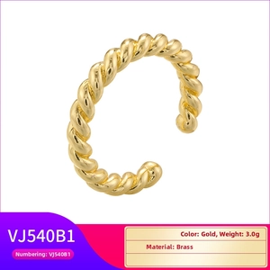 Detailed macro shot of adjustable brass twisted rope ring with a polished gold finish