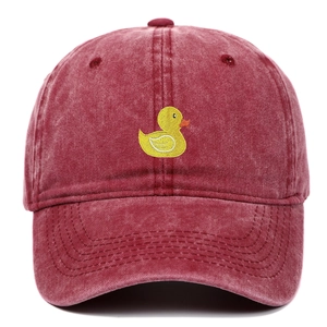 Detailed close-up of the vintage washed burgundy cotton fabric and yellow duck embroidery