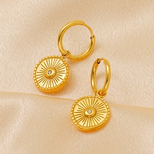 Vintage 18K gold plated sunburst earrings with centered diamond on champagne silk