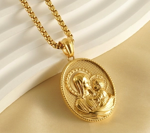 Macro view of 18k gold plated oval Virgin Mary relief pendant with textured edge details
