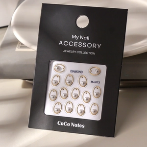 Detail of luxury gold oval frames with faux pearls for nail art DIY decoration
