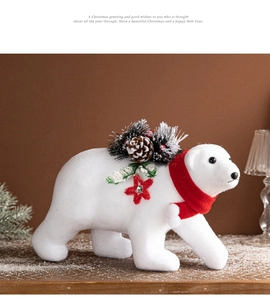 Detailed view of a white polar bear ornament with red scarf and pine cone Christmas decor