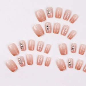 Pink ombre press-on nails with butterfly pattern and rhinestones in medium square shape