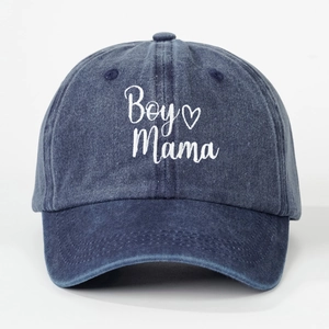 Detail of Boy Mama embroidery and heart icon on a navy blue washed denim baseball cap