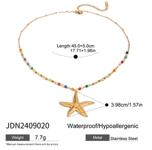 Macro shot of gold stainless steel necklace with color beads and starfish pendant detail