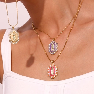 Detail of a gold Virgin Mary necklace with colorful zircon and hexagon enamel pendant
