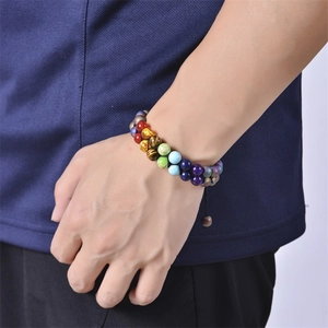 Close-up of double-layer Seven Chakra stone beads bracelet on wrist with adjustable cord