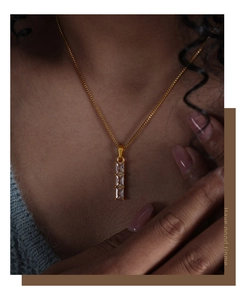 Detail view of a 18k gold plated necklace with three vertical baguette zircon stones
