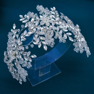 Macro detail of handmade silver bridal crown with crystal leaves and flower beads