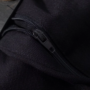 Detailed close-up of premium black diagonal twill fabric and heavy-duty metal zipper