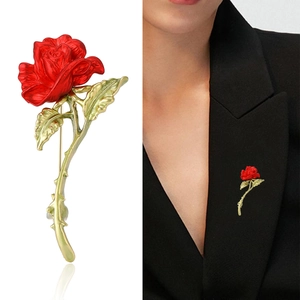 Elegant vintage red rose brooch with gold leaves on white background and model suit