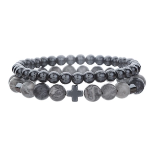 Detail of 4mm and 6mm hematite beaded bracelets featuring a black cross and lava tiger eye stones