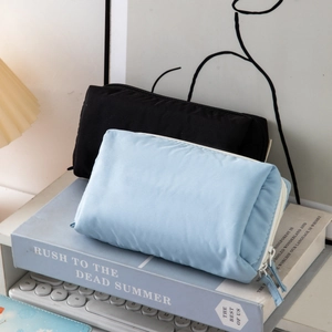 Minimalist large capacity mesh pencil case in light blue and black on a desk