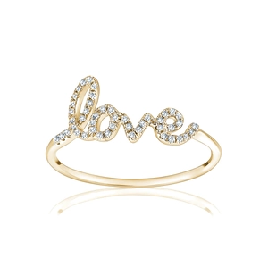 Macro detail of gold LOVE ring with pavé-set sparkling crystals and high-polish finish