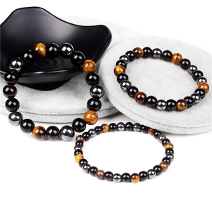 Macro shot of tiger eye, obsidian and hematite beaded bracelets in various sizes