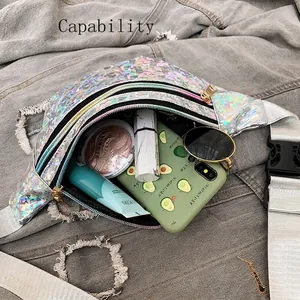 Silver laser holographic waist bag with large capacity on denim background