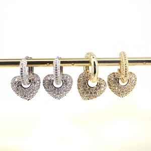 Copper heart earrings with micro-inlaid zircon in gold and silver finish on display