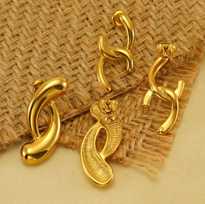 Detail of 18k gold plated geometric hoop earrings showing polished finish and textured back