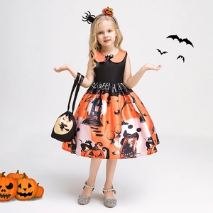 Detail of Halloween witch dress with pumpkin prints and matching orange handbag for girls