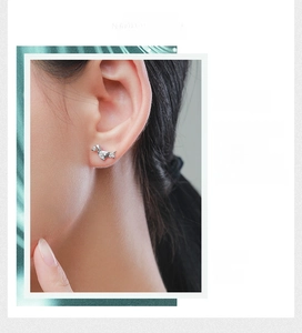 Close-up of s925 silver dachshund puppy stud earrings with white zircon on ear