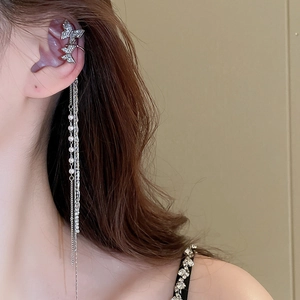 Silver butterfly ear cuff with diamond zircon and long pearl tassels worn by a model