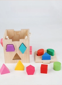Macro view of colorful geometric blocks and smooth wooden shape sorter box for kids