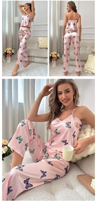 Detail of pink satin pajama set featuring colorful butterfly prints and silky texture