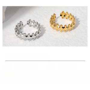 Macro detail of industrial gear-style adjustable stainless steel ring in gold and steel