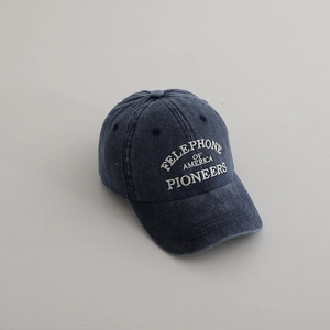 Close-up of navy blue washed cotton baseball cap with white vintage letter embroidery