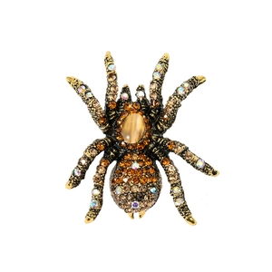 Close-up of vintage spider brooch with cat eye stone and champagne rhinestones on alloy