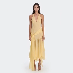 Pale yellow chiffon halter maxi dress with deep V-neckline and tiered ruffle hemline