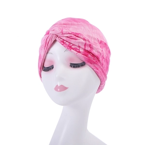 Detailed view of a pink tie-dye turban hat for women with a stylish front twist knot