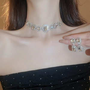 Elegant silver necklace and oval rhinestone earrings set for women on model
