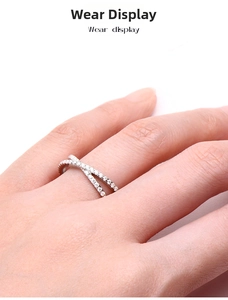 Macro detail of S925 sterling silver X-shaped ring with micro-pave moissanite stones