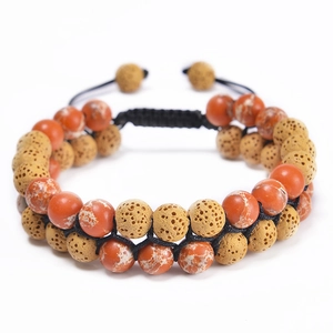 Detail of double-layer woven bracelet with red jasper and porous volcanic lava stone beads