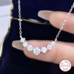 Macro detail of 925 sterling silver necklace featuring seven radiant moissanite stones