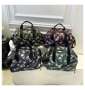 Close-up of gothic skull and rose patterns on large capacity nylon travel bags