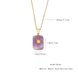 Detail view of purple natural stone pendant with gold sun pattern and size markings
