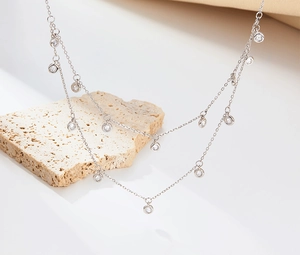 Detail of a double-layered 925 silver necklace with sparkling round zircon stones