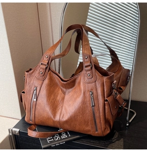Macro view showing vintage brown PU leather tote bag with side pocket and handle details