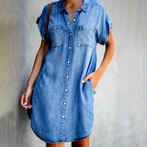 Detailed view of denim shirt dress featuring lapel collar and chest pockets